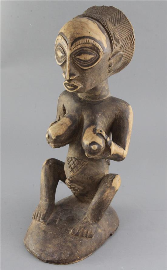 An African carved wood female fertility figure, 42cm